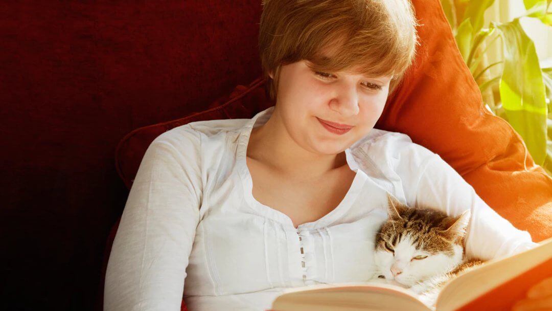 Girl embracing an emotional support cat