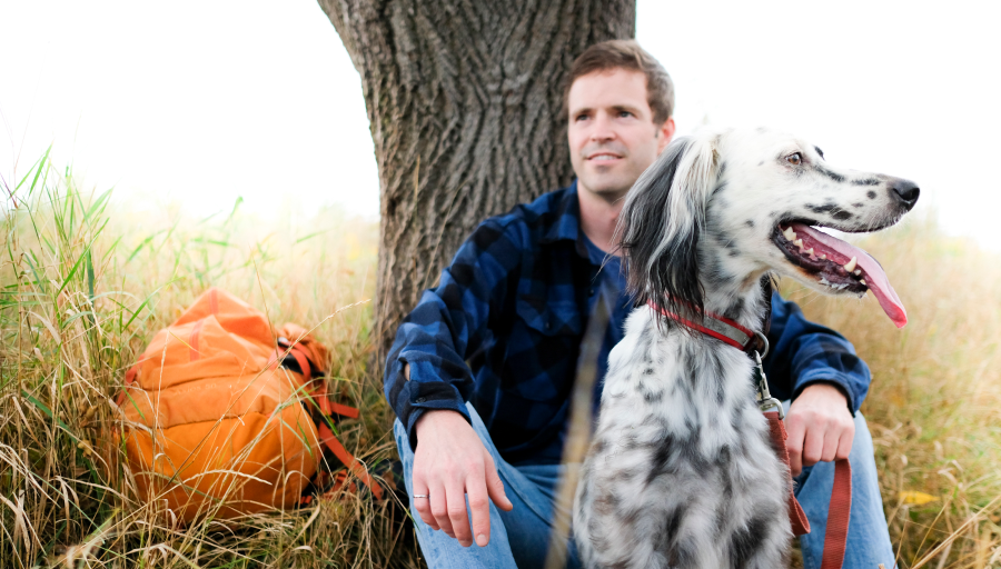 appearance_-_a_person_sitting_next_to_a_dog