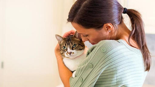 Woman cuddling cat